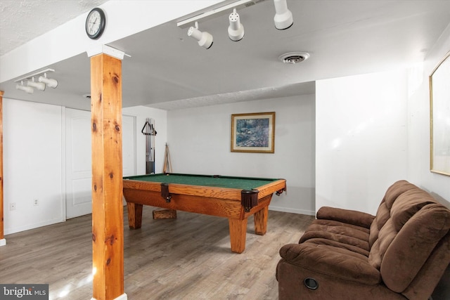 game room featuring hardwood / wood-style flooring, pool table, and a textured ceiling