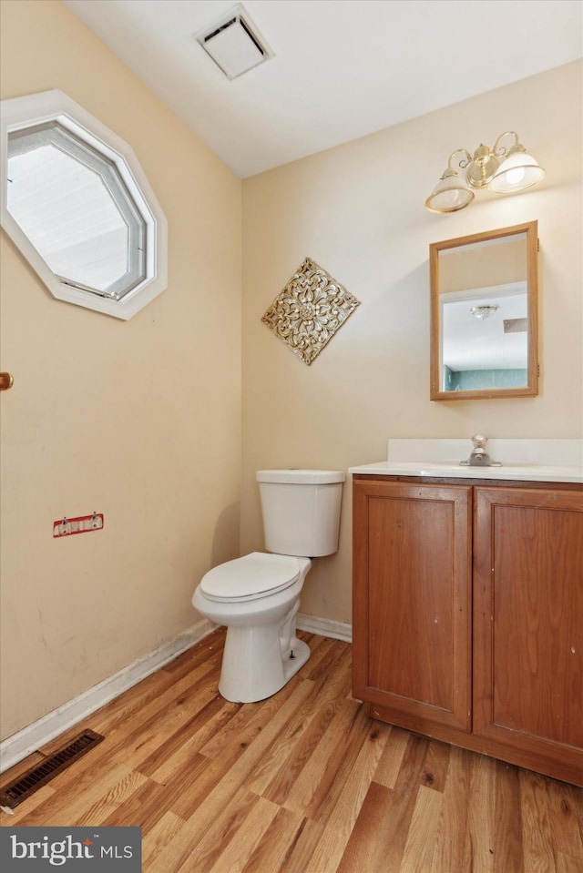 bathroom with vanity, hardwood / wood-style floors, and toilet