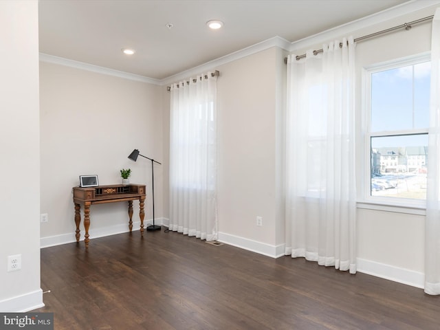 spare room with ornamental molding and dark hardwood / wood-style floors