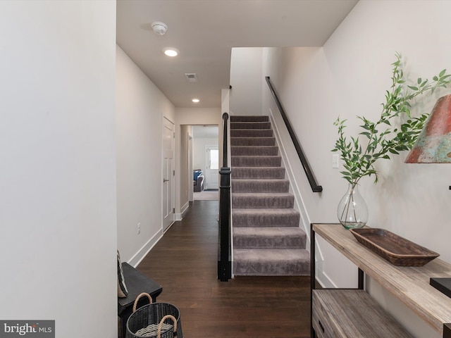 stairway with hardwood / wood-style floors