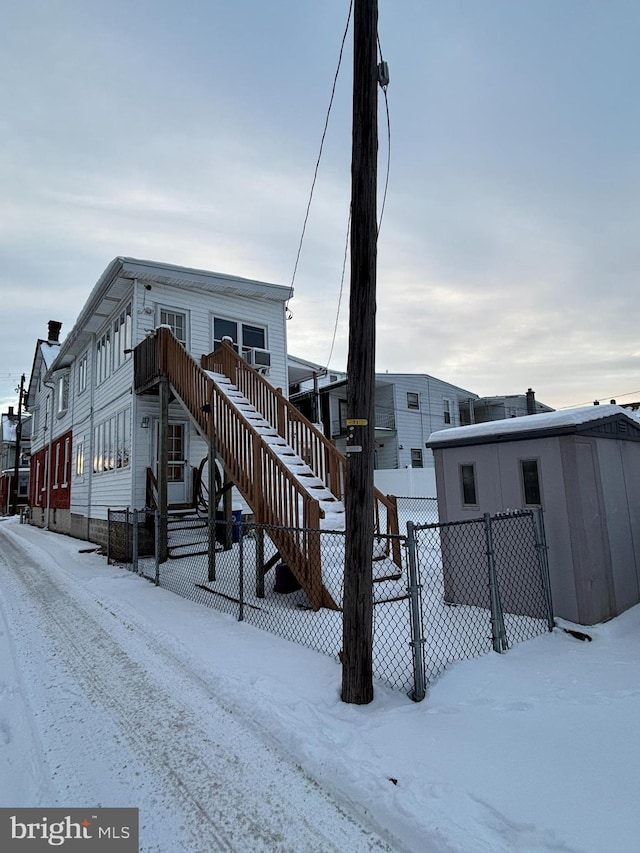 view of snow covered rear of property