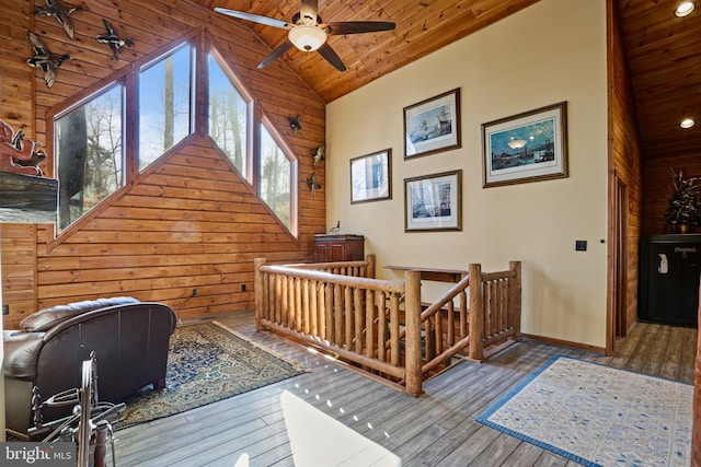 interior space featuring wooden walls, high vaulted ceiling, hardwood / wood-style floors, and wooden ceiling