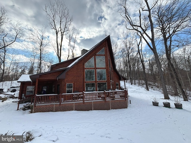 view of snow covered back of property