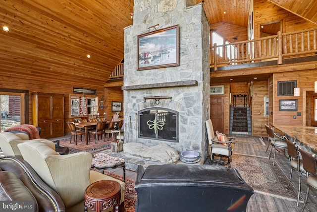 living room with a fireplace, wood ceiling, wood-type flooring, and wood walls