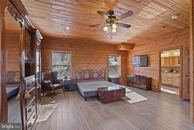 bedroom featuring wood ceiling, hardwood / wood-style floors, and multiple windows