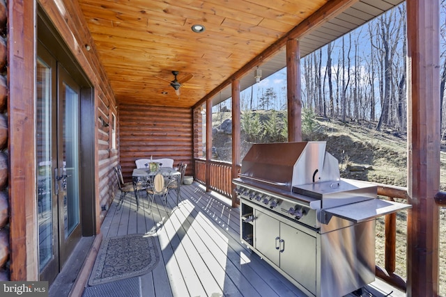 wooden terrace featuring an outdoor kitchen and area for grilling