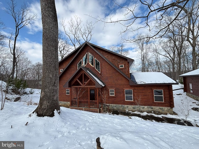 view of snow covered back of property