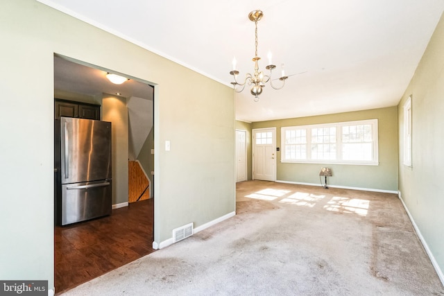 interior space with an inviting chandelier and carpet