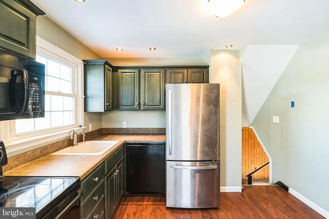 kitchen featuring dark hardwood / wood-style flooring, sink, and black appliances