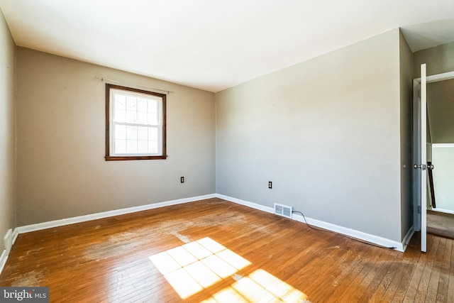 empty room with hardwood / wood-style flooring