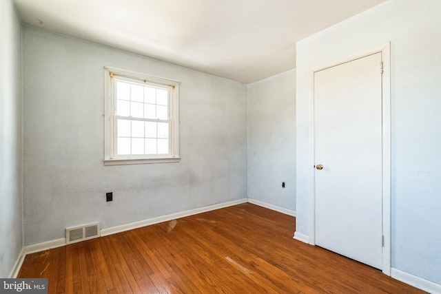 spare room featuring hardwood / wood-style floors