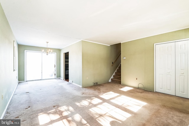 unfurnished living room featuring light carpet and a notable chandelier