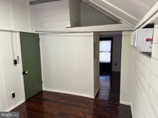 interior space featuring vaulted ceiling, dark hardwood / wood-style floors, and wooden walls