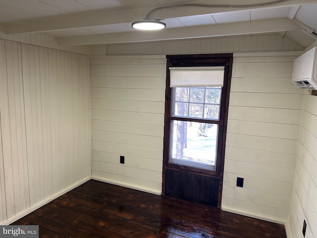 empty room with dark wood-type flooring and wooden walls