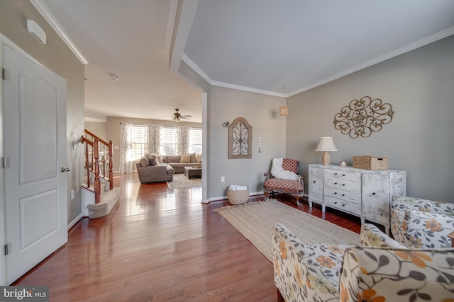 living area featuring crown molding and hardwood / wood-style flooring