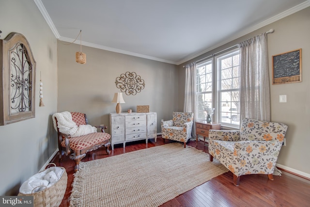 living area with crown molding and wood-type flooring