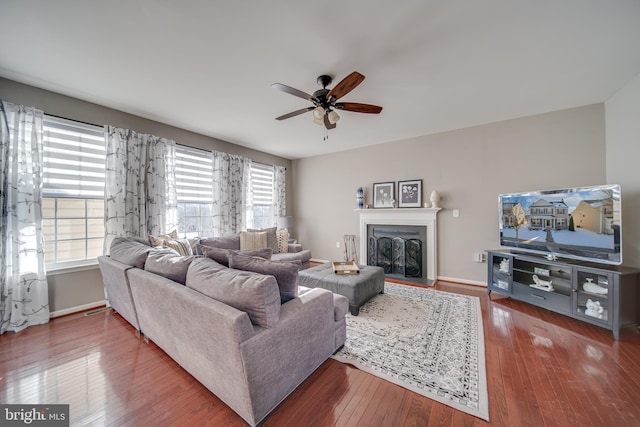 living room featuring hardwood / wood-style flooring, a wealth of natural light, and ceiling fan