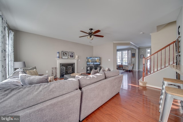 living room with hardwood / wood-style flooring and ceiling fan