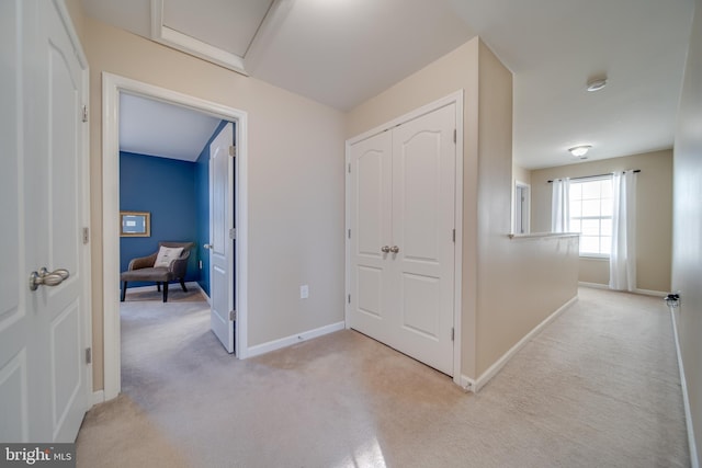 corridor featuring light colored carpet