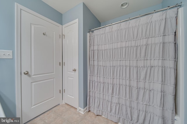 bathroom with tile patterned floors and walk in shower