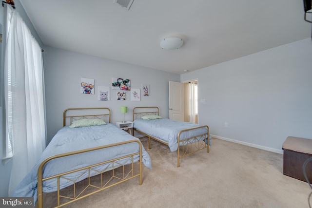 carpeted bedroom featuring multiple windows