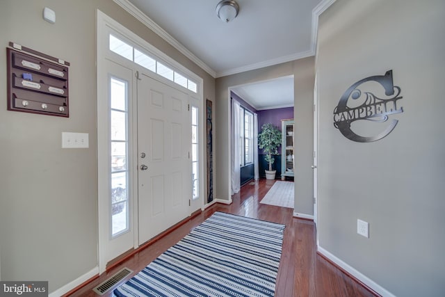 foyer with ornamental molding and wood-type flooring