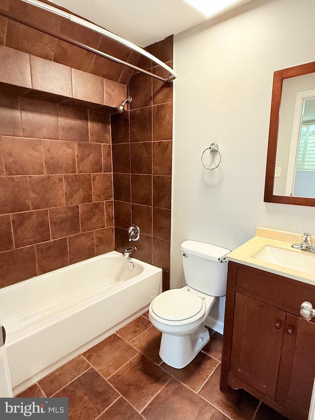 full bathroom with tiled shower / bath combo, vanity, and toilet