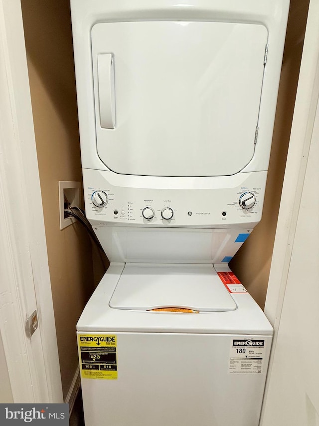 laundry room with stacked washer and clothes dryer