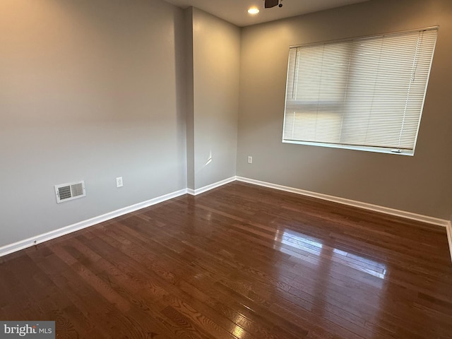 unfurnished room featuring dark wood-type flooring