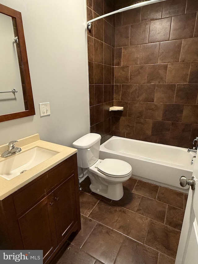 full bathroom featuring vanity, toilet, and tiled shower / bath combo