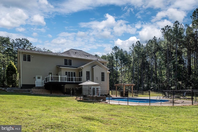 back of house featuring a fenced in pool, a yard, and a pergola