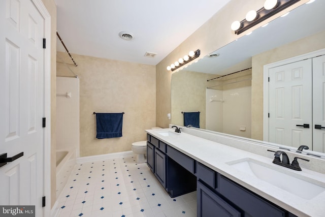 full bathroom featuring tiled shower / bath combo, vanity, and toilet