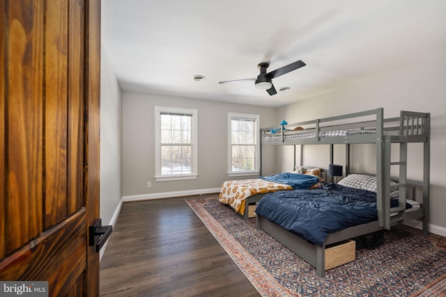 bedroom with dark hardwood / wood-style floors and ceiling fan