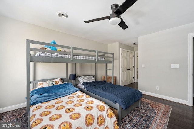 bedroom with ceiling fan and dark hardwood / wood-style floors