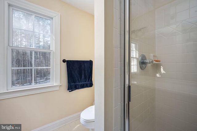 bathroom with an enclosed shower and toilet