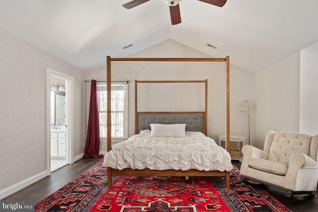 bedroom featuring lofted ceiling, connected bathroom, dark hardwood / wood-style flooring, and ceiling fan