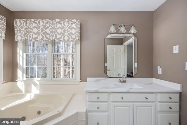 bathroom with vanity and a relaxing tiled tub