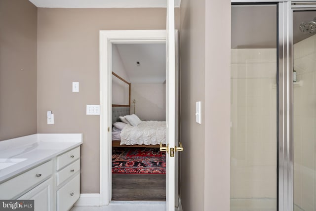 bathroom with vanity and a shower with door