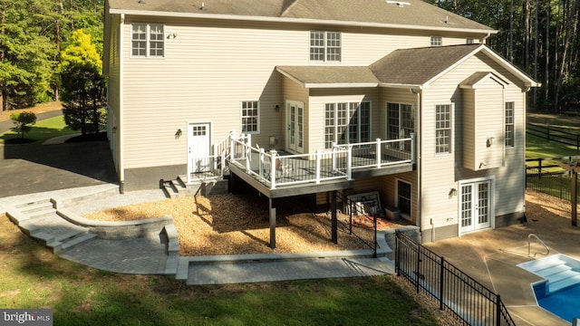 back of property featuring french doors and a deck