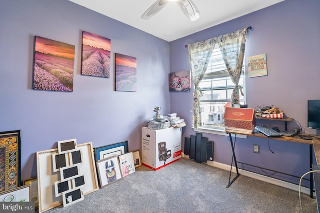 interior space with carpet floors, a ceiling fan, and baseboards