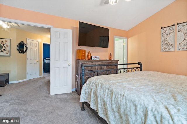 carpeted bedroom featuring baseboards and vaulted ceiling