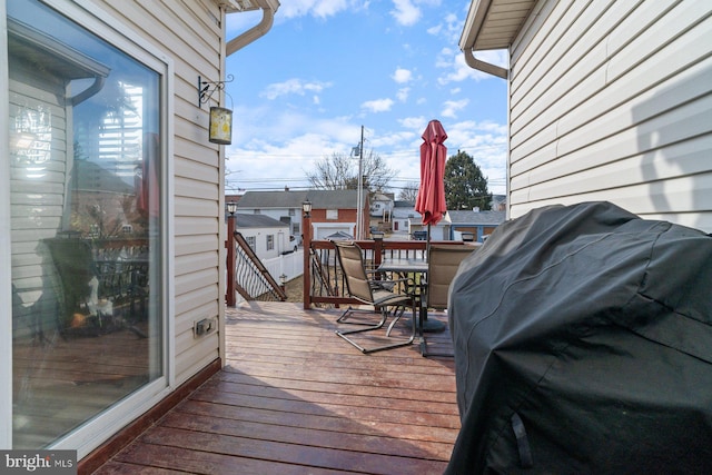 wooden deck featuring outdoor dining area and area for grilling