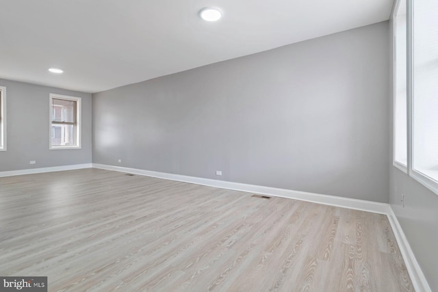 spare room featuring light hardwood / wood-style flooring and a wealth of natural light