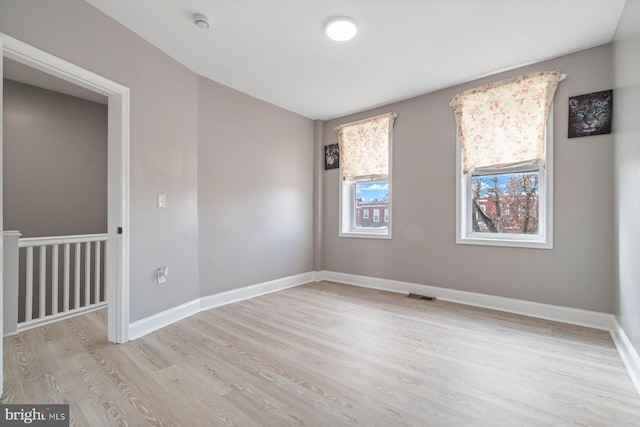 spare room with light hardwood / wood-style floors