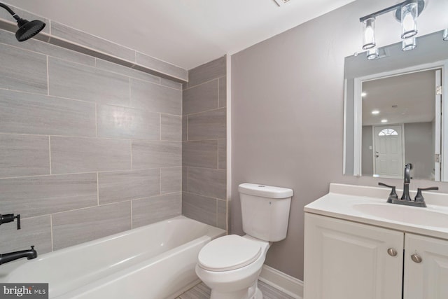 full bathroom featuring vanity, toilet, and tiled shower / bath combo