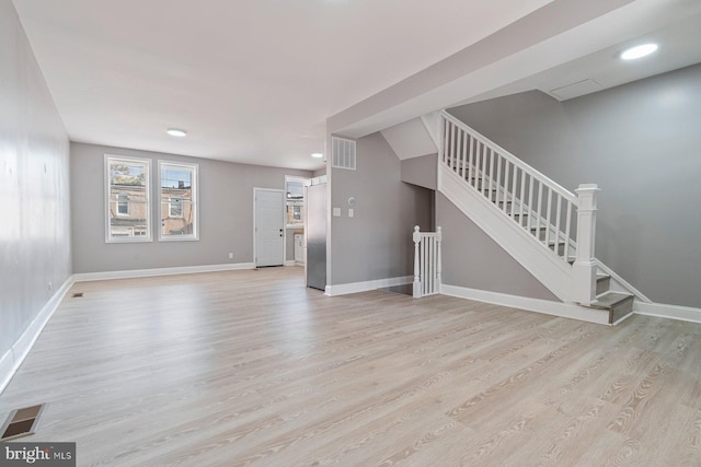 unfurnished living room featuring light wood-type flooring