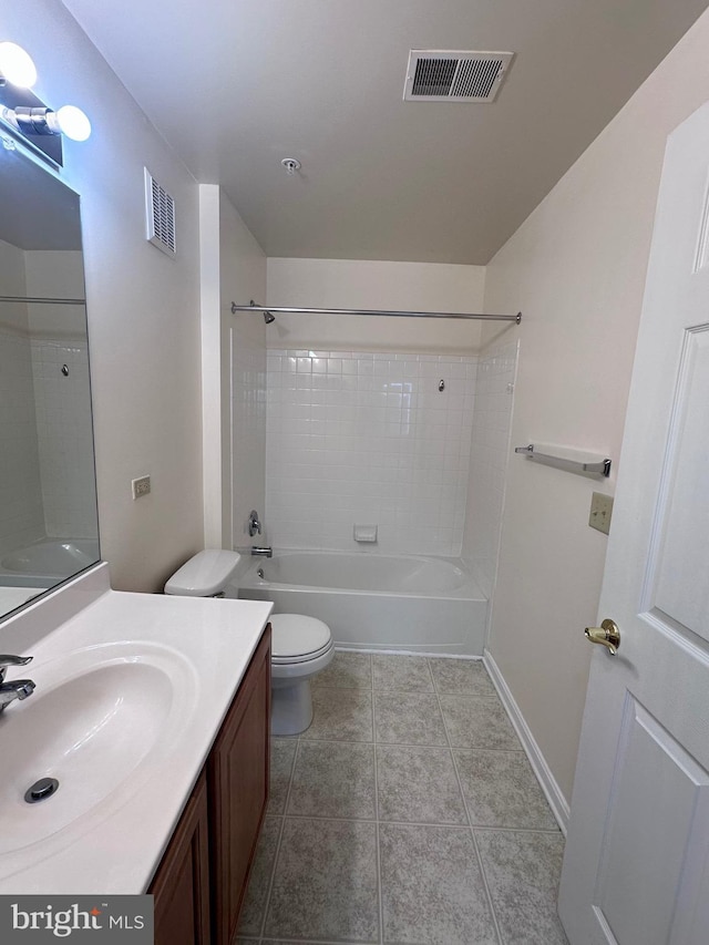 full bathroom featuring tiled shower / bath combo, vanity, tile patterned flooring, and toilet