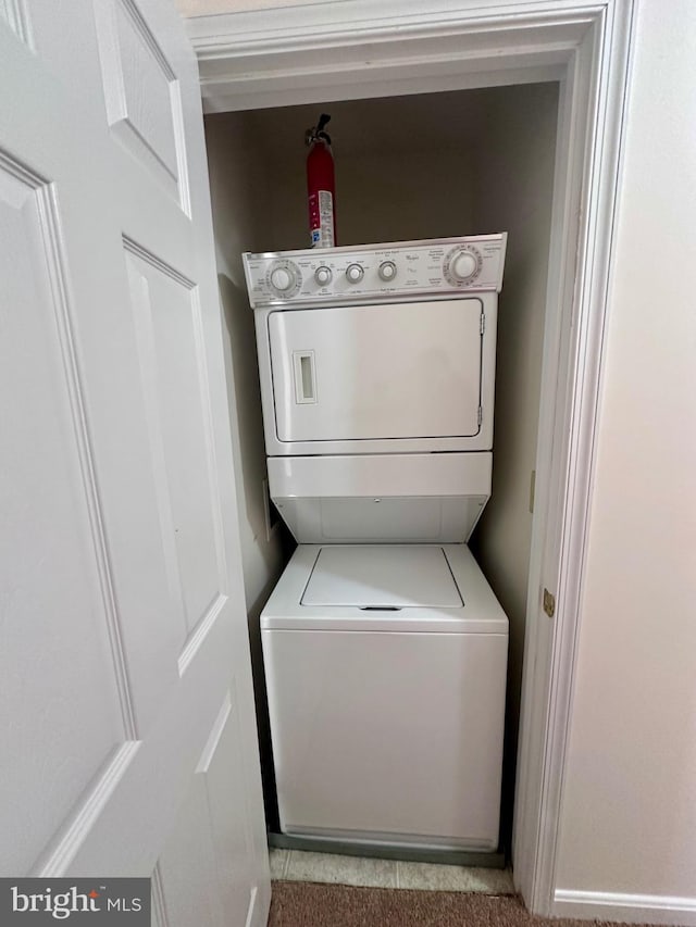 laundry area featuring stacked washer and clothes dryer