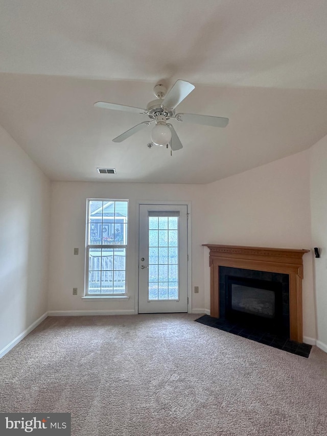 unfurnished living room featuring ceiling fan and carpet