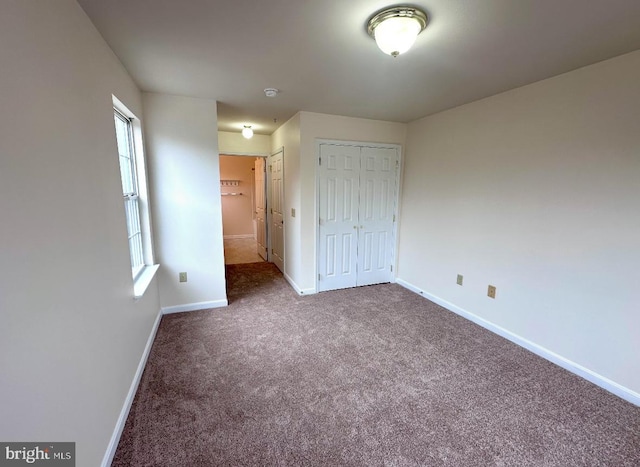 unfurnished bedroom with carpet floors and a closet